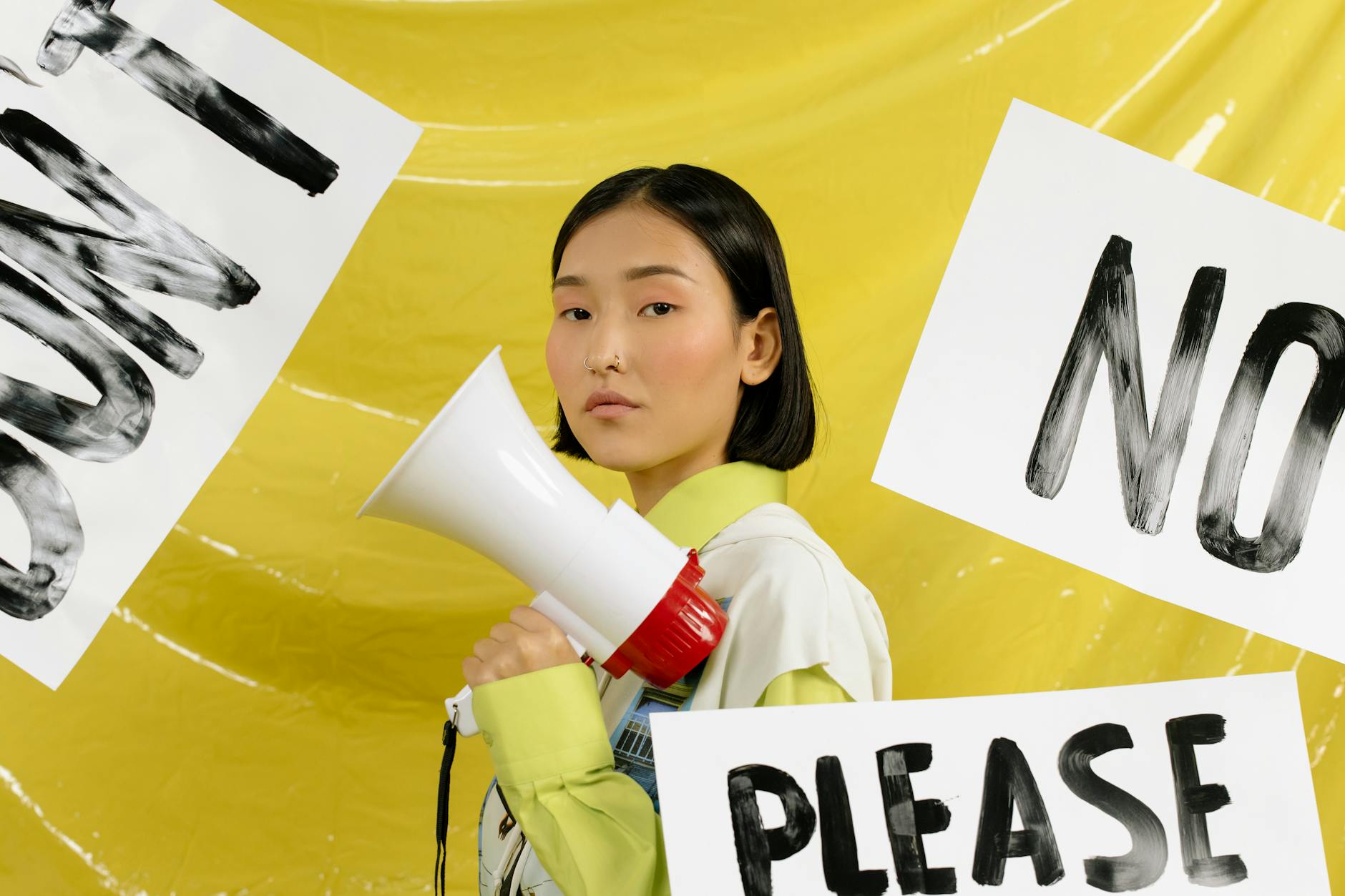 A person holding a sign that reads 'Prayers are not enough. Take action.'
