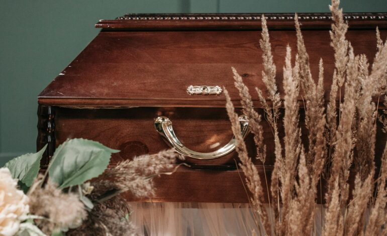 A person sitting by a tree in a peaceful natural setting, reflecting on life and loss, symbolizing secular grief and remembrance.